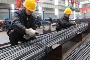 GANYU, CHINA - APRIL 01: (CHINA OUT) Two employees tie up steel bars at a steel-making plant on April 1, 2013 in Ganyu, China. China's Purchasing Managers Index (PMI) rose to 50.9 percent in March from 50.1 percent in February, according to the National Bureau of Statistics (NBS). (Photo by ChinaFotoPress/ChinaFotoPress via Getty Images)